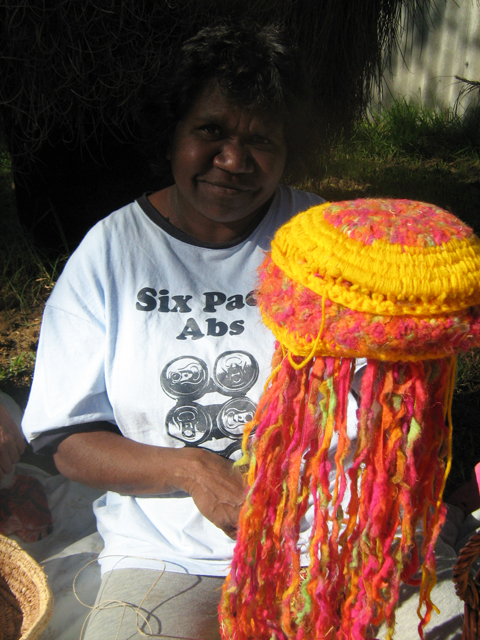 Woman holding a colourful beanie