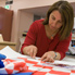 Conservator Carmela Mollica working on Makybe Diva jockey silks worn by Glen Boss.