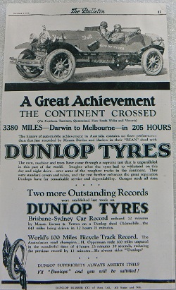 Black and white advertisement with an image of an two men sitting in an open-topped car. Below is printed text, some of which reads: 'A Great Achievement / THE CONTINENT CROSSED / 3380 MILES - Darwin to Melbourne - in 205 hours / DUNLOP TYRES'.