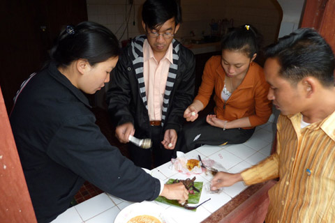 Four people share food.