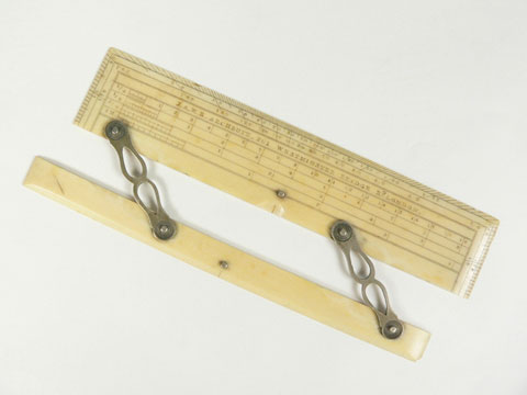 A hinged ruler from a set of drawing instruments.