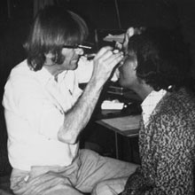 Fred Hollows examining an Aboriginal woman's eye.