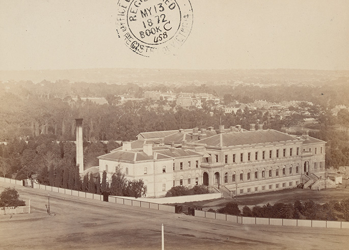sepia-toned photograph of a large three-storey white building