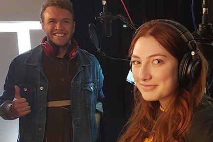 a man and woman pose for the camera