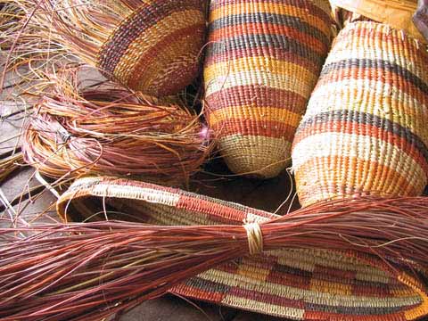Multi-coloured striped woven basketry works by Helen Guyula Djaypala.