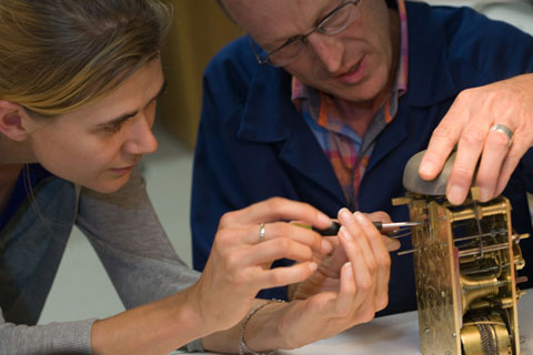 An extra pair of hands is sometimes required to perform some tasks in clock assembly.
