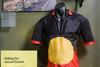 A display featuring Alby Clark's red, yellow and black bicyle outfit