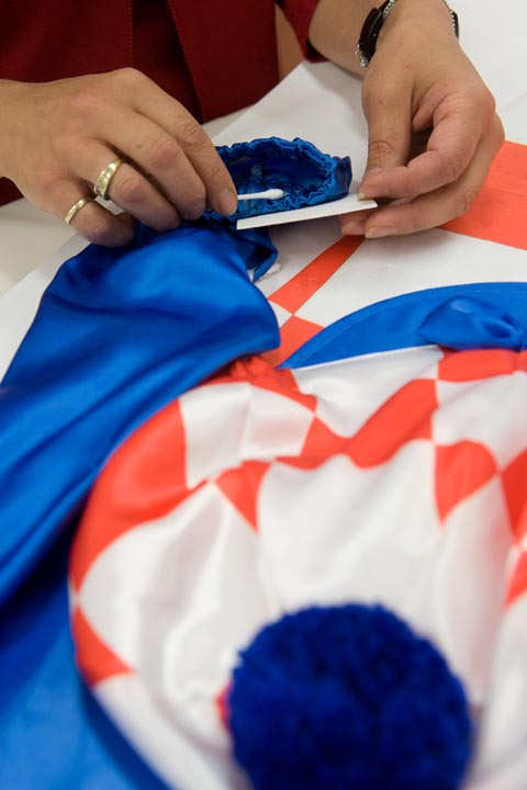 Removing the double-sided adhesive residue from the sleeve cuff.