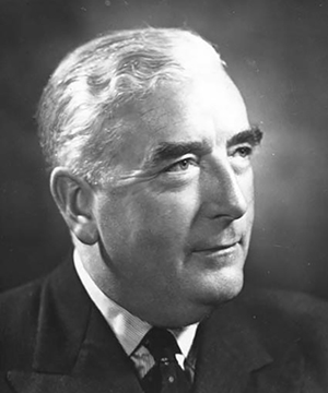 Sir Studio three-quarter profile portrait of Menzies, smiling.