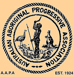 A stylised image of an Aboriginal man holding a spear and boomerang with an emu and kangaroo on either side. The words ‘Australian Aboriginal Progressive Association’ encircle the image
