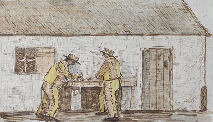 two men in yellow outfits stand writing at a table immediately outside a cottage