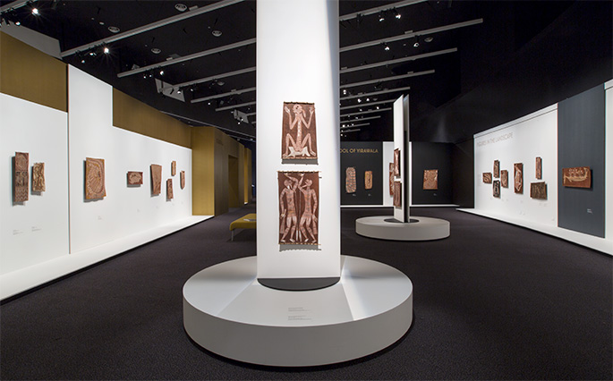 Indigenous artworks on display in an exhibition gallery.