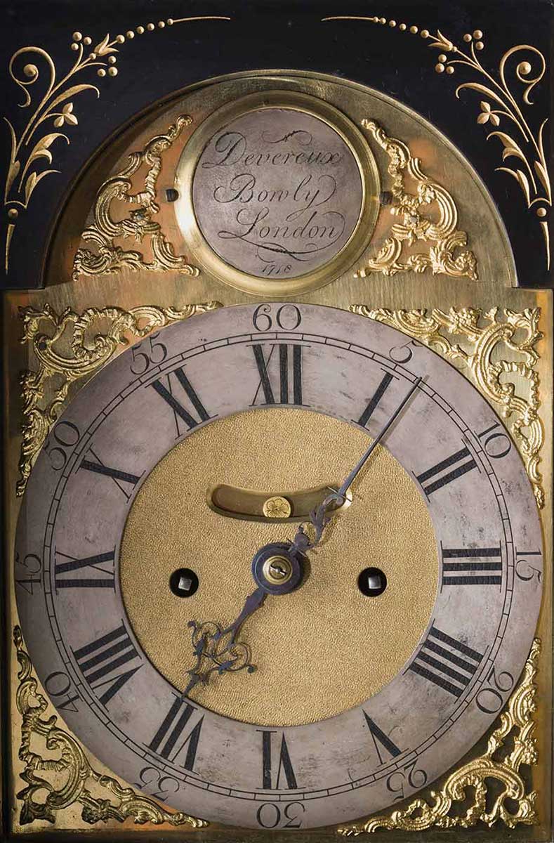 A close-up of part of the face of a mantelpiece clock. - click to view larger image