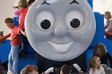 Young visitors climbing on a large Thomas the Tank Engine.