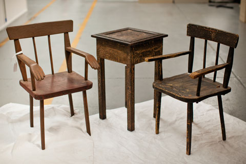Two wooden chairs either side of a small wooden table.