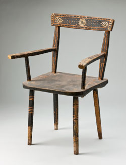 A wooden chair painted primarily in a dark brown, decorated in shades of orange and light brown on the arms, legs and back.