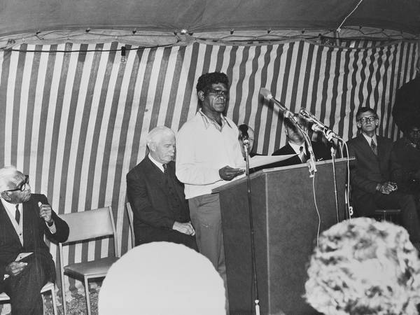 Charlie Carter receives the title deed to Lake Tyers on behalf of residents. Rohan Delacombe, Governor of Victoria, is to his right. Pastor Doug Nicholls, far left, looks on.