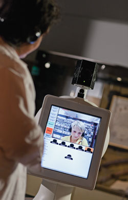 Angela Casey presents to a student from regional Australia at the launch of the Museum Robot.