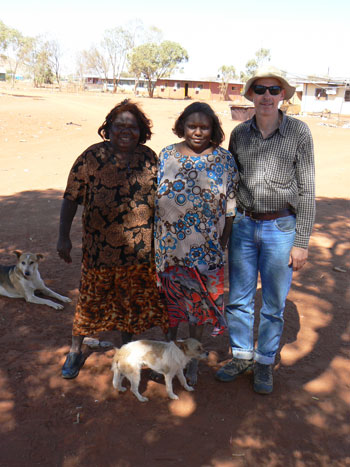 peter-thorley-3.jpg Two women and a man standing in an open expanse of land. A number of houses can be seen in the background.