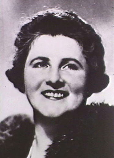 Black and white photo of smiling Dame Enid.