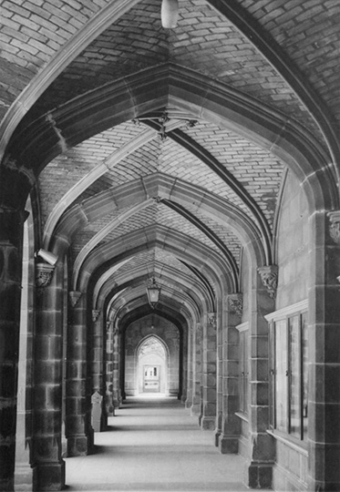 photo taken at one end of an empty cloister