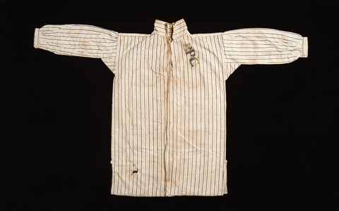 Cream-coloured collared shirt with grey stripes. 'BPC' is written in black across the right chest.
