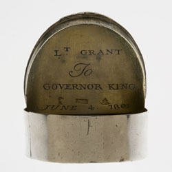 Silver snuff box with lid open to reveal engraved inscription.