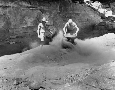 Fred McCarthy and Frank M Setzler shovelling and sifting cave deposits in front of picture gallery, Gunbalanya, October 1948.