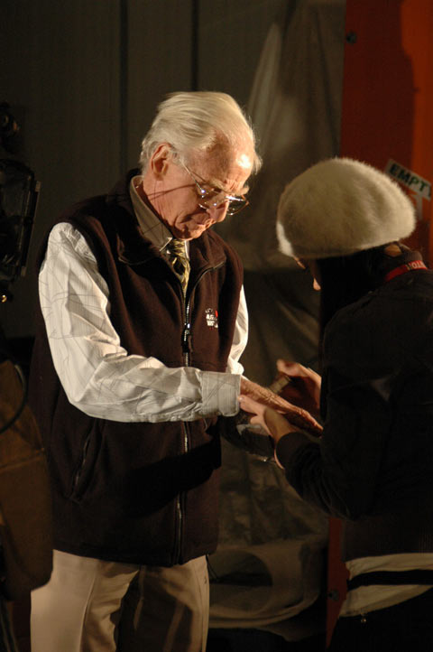 Make-up artist Mae Lee powders Hermann's hands to prevent shine in the close-up shots.