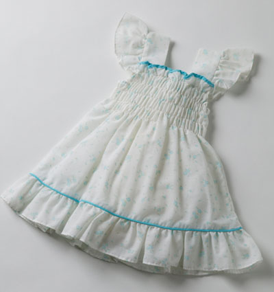 White child's dress with smocked front and aqua trim.