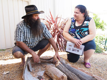 barbara-paulson-1.jpg Two people examining indigenous artifacts.