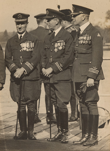 A black and white photo of Kingsford Smith in full RAAF uniforms with canes.