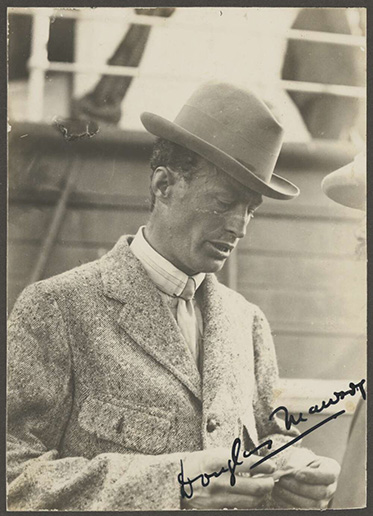 black and white photo of man in suit and hat