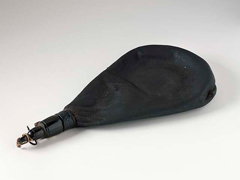 A tear-dropped shaped leather water bottle.