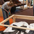 Installing the giant Griffin puppets in the Landmarks gallery.