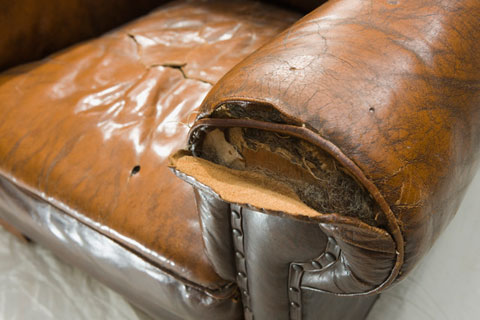 Detail of damaged stitching on the front of the arm rest.
