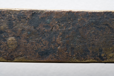 Close up image of a section of the greyish-brown surface of the Leichhardt nameplate.