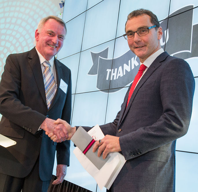 Michael Parker handing a cheque to Mathew Trinca.