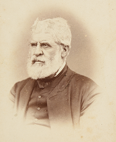Daguerreotype of white-haired, bearded man in dark suit.