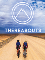 Thereabouts 150w Two people cycling on a dirt road leading across a vast plain