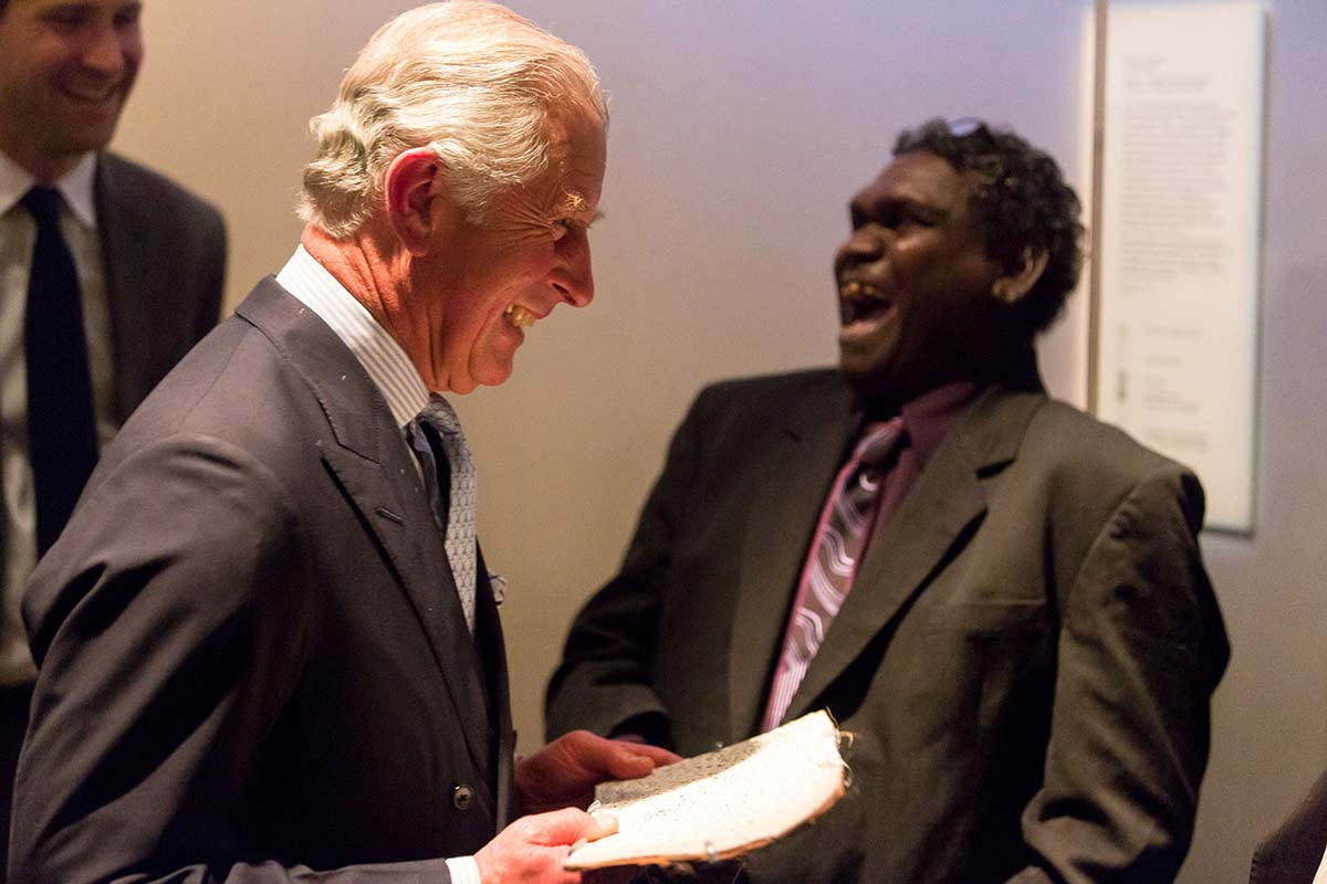 HRH Prince smiling with Aboriginal artist Wukum Wanambi laughing. - click to view larger image