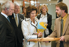Curator David Kaus explaining the workings of a shield to His Majesty King Carl XVI Gustaf and Her Majesty Queen Silvia of Sweden.