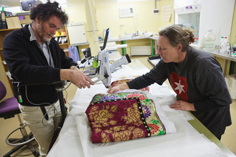 David Hallam sets up the XRF machine as Deb Spoehr chooses an area of the costume to be tested.