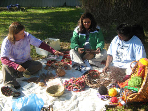 Three women with the weaving objects