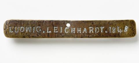 Front view of the Leichhardt nameplate which is a piece of brass 15 cm x 2 cm marked LUDWIG. LEICHHARDT. 1848
