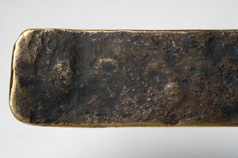 Close up image of an end section of the Leichhardt nameplate detailing the greyish-brown uneven surface.