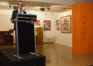 Director Andrew Sayers welcomes guests. Behind him is the 1970s era ‘office.