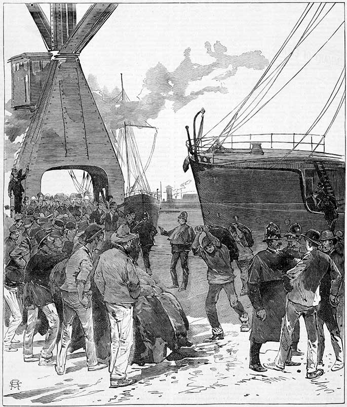 A handful of men carrying sacks from a moored ship surrounded by large numbers of jeering men kept at bay by a handful of police.