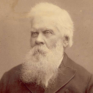 studio photographic portrait of older man, with white hair and long white beard
