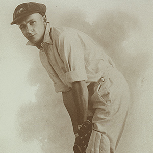 Autographed photo of Don Bradman posing with cricket bat in 1928.